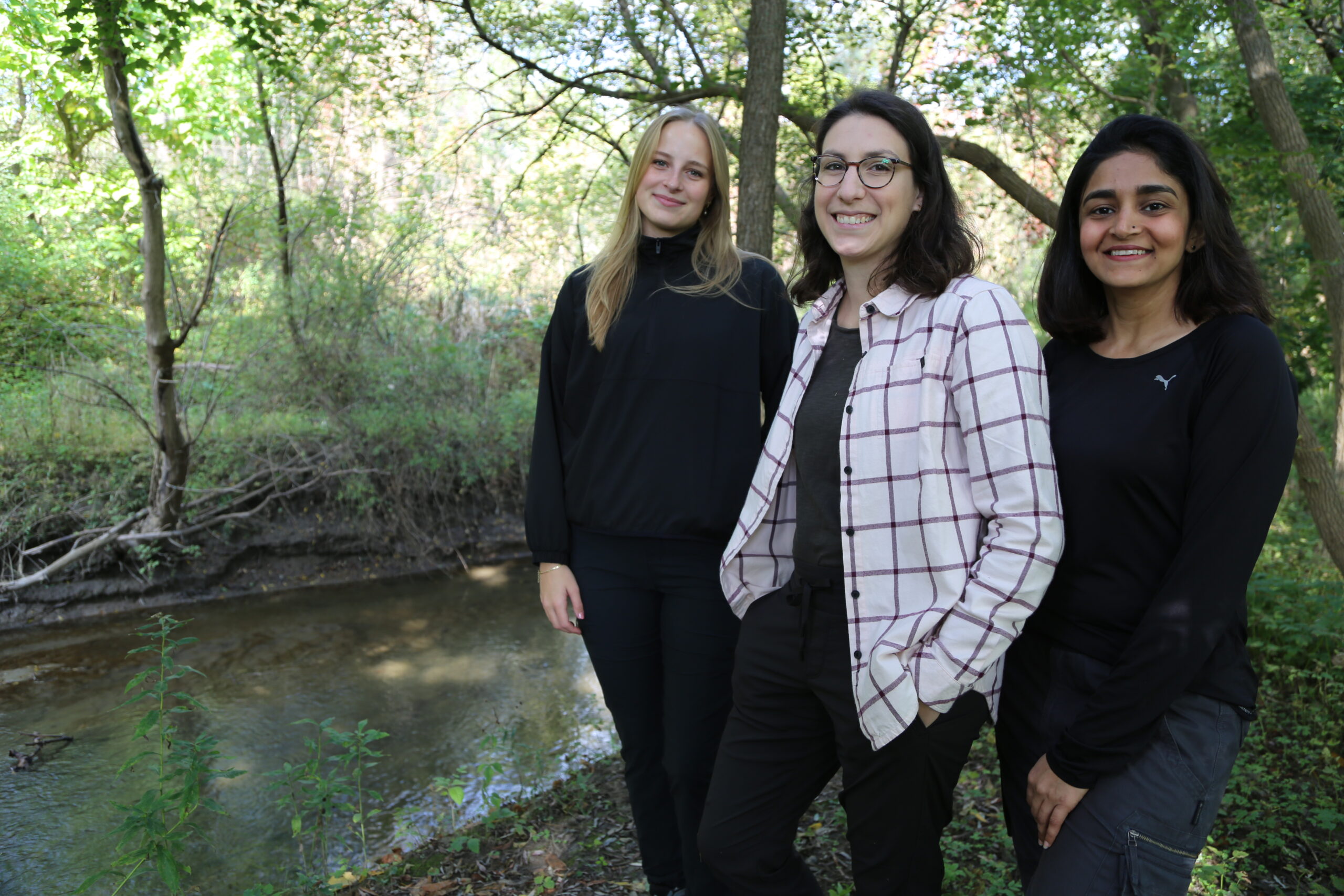 Kate Pearson, Elli Papangelakis and Priyanka Hire along the Ancaster Creek